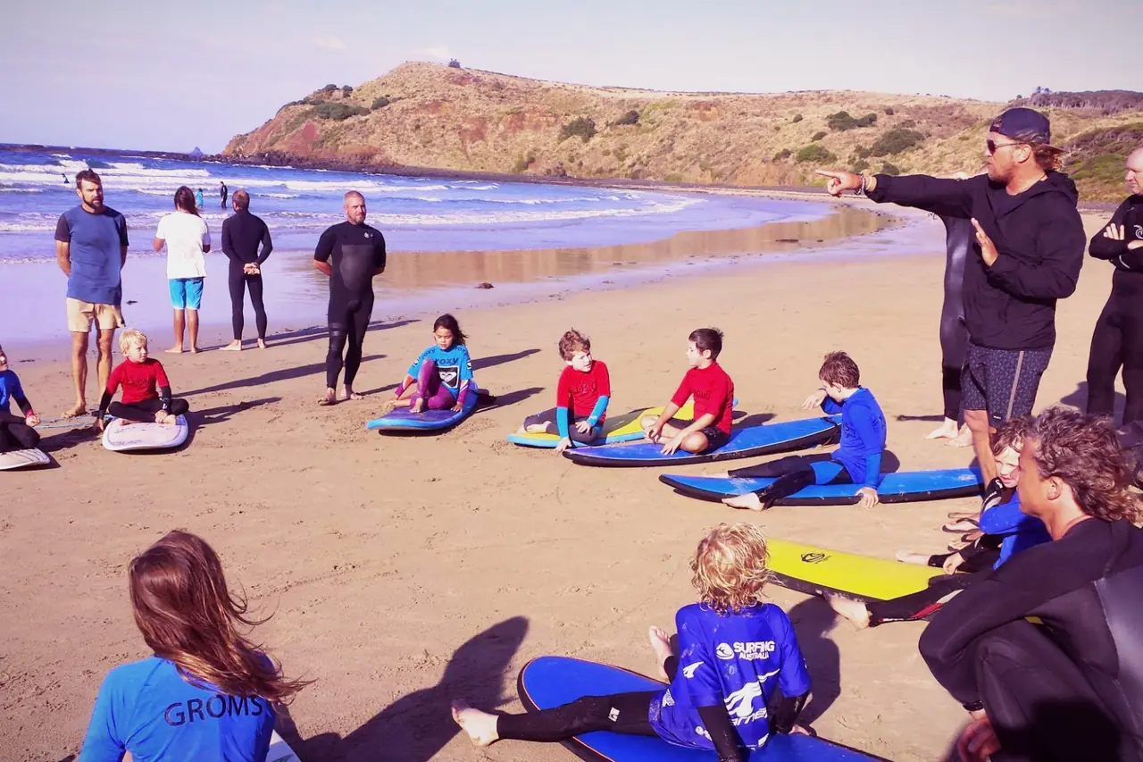 Surfboards lined up on the sand