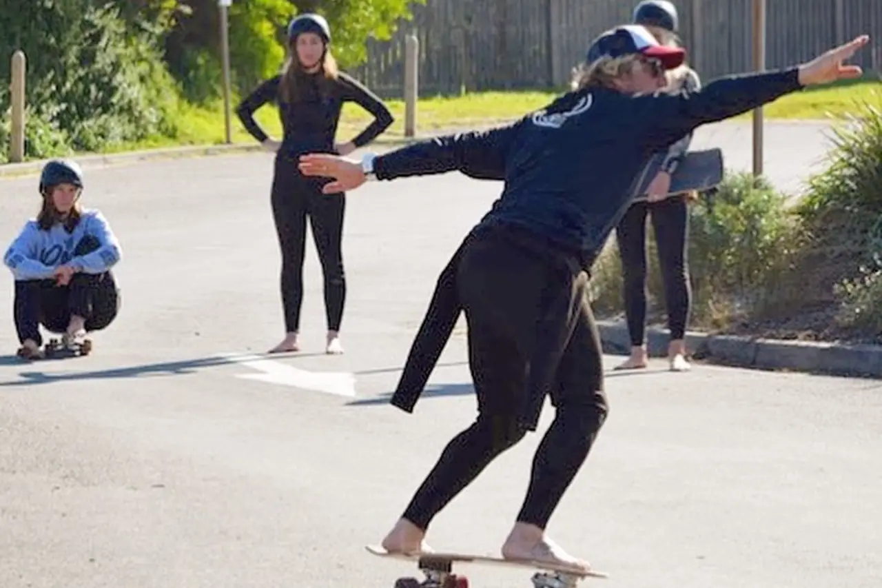 A coach running a surf presentation for a group