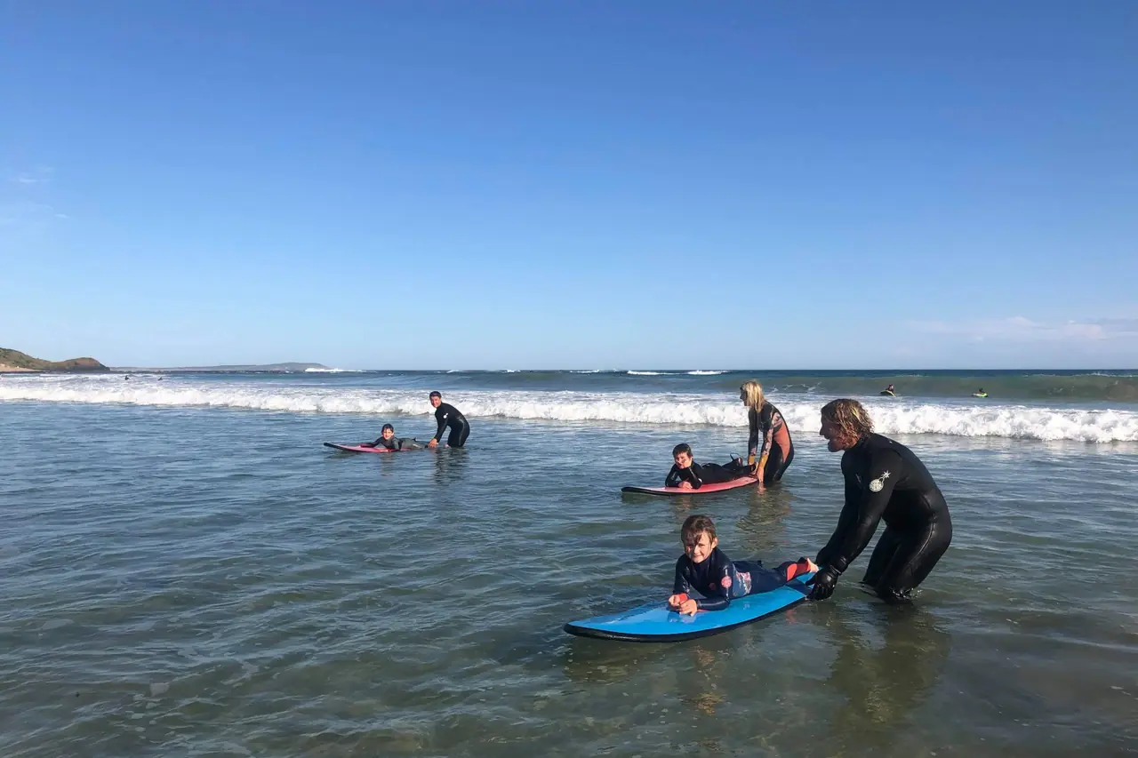 A Pro Surf Coaching coach working with a student in the surf