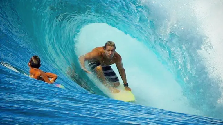 A Pro Surf Coaching surfer riding deep inside a barrelling wave
