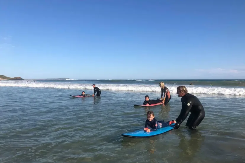 A Pro Surf Coaching coach working with a student in the surf