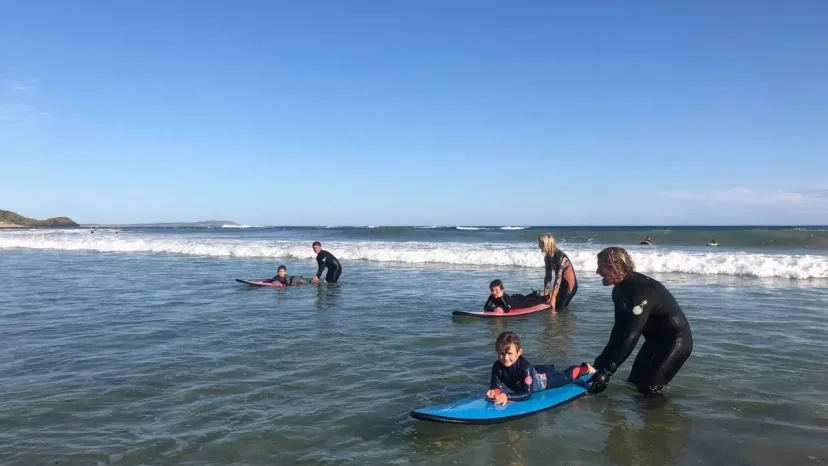 A Pro Surf Coaching coach working with a student in the surf