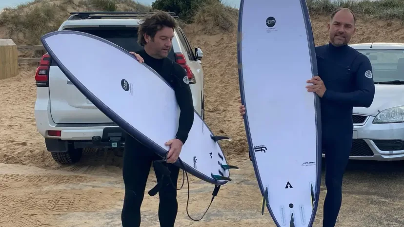 Masters program surfers on the beach with their boards