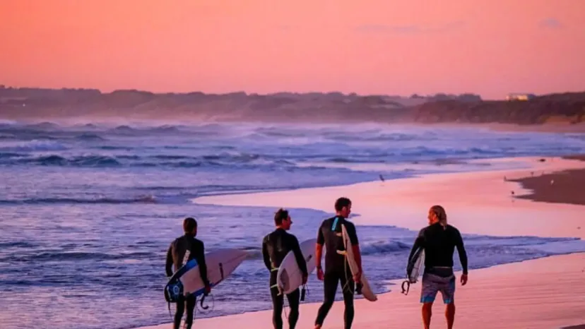Surfers walking down the beach at Smiths Beach, Phillip Island