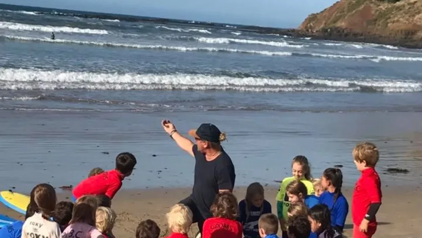 A coach running a surf presentation for a group