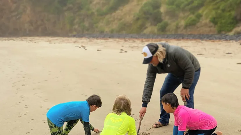 Kids on the beach at a Pro Surf Coaching grommets session