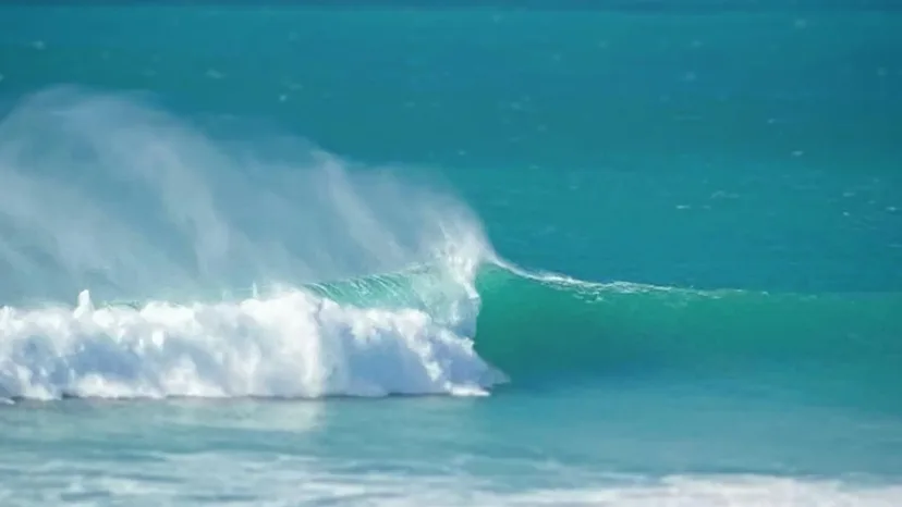An older surfer riding a wave at Phillip Island